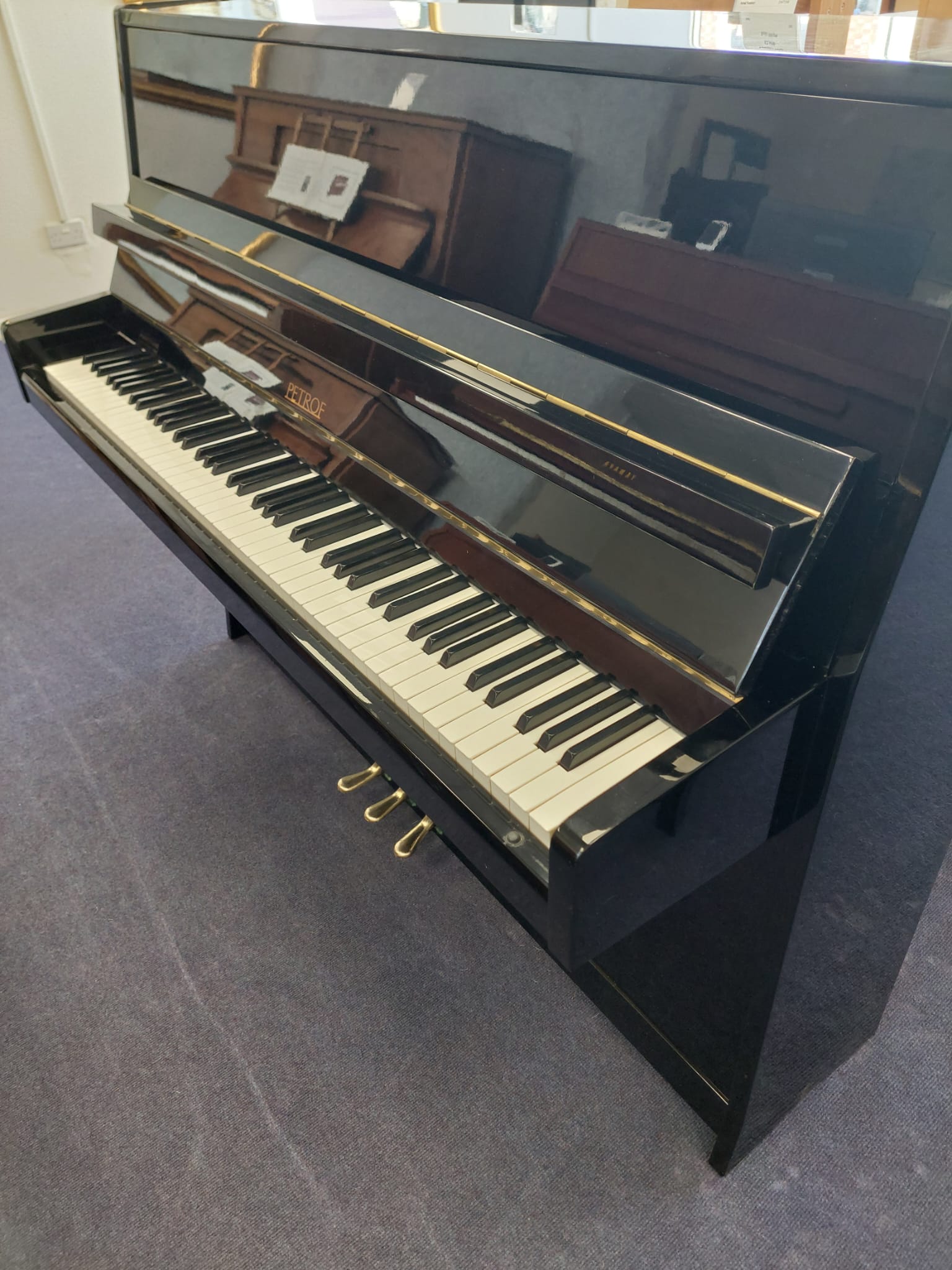 Petrof 116 Upright Piano in Black Polyester – Gallery image – Roberts Pianos Oxford